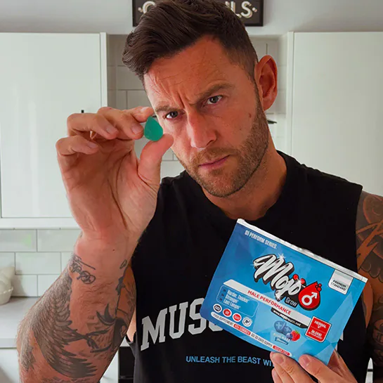 A customer holding up a MOJO™ GROW gummy and pack
